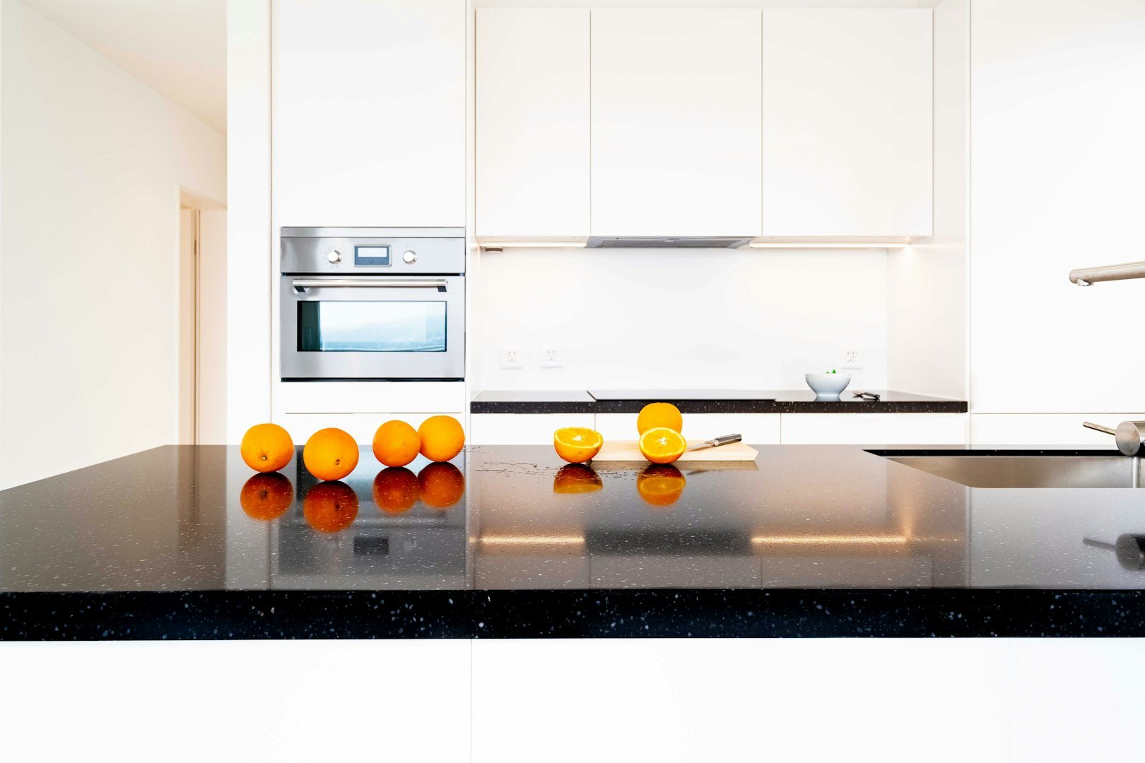 yellow round fruits on white kitchen counter
